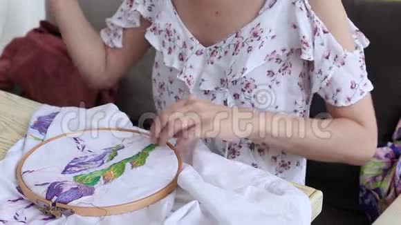 桌子上的女孩用针头缝纫针线活刺绣爱好手工艺视频的预览图