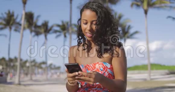 夏天在智能手机上聊天的漂亮女人视频的预览图