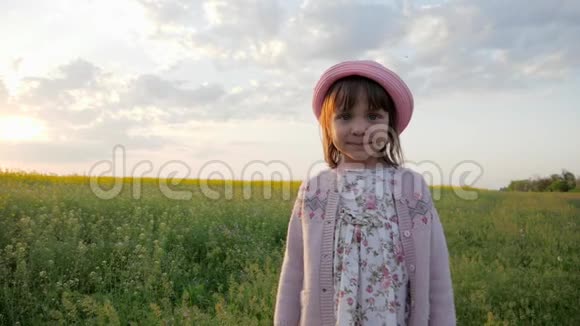 可爱的小女孩肖像背景花田巴拿马的女孩子头戴帽子孩子看镜头快乐视频的预览图