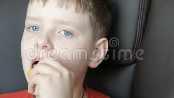 蓝眼睛雀斑少年吃薯片特写镜头视频的预览图