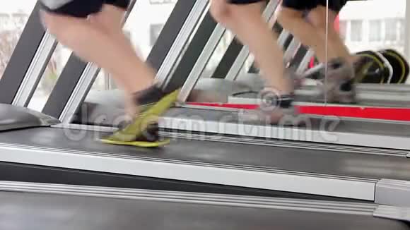 男人在跑步机上跑步为腿部肌肉做调色锻炼健康生活视频的预览图