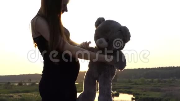 4K孕妇日落时和熊玩视频的预览图