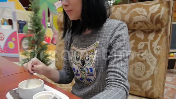 一个年轻女孩在咖啡馆餐馆喝咖啡视频的预览图