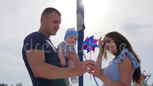 周末男性与配偶和孩子在户外孩子在爸爸手中靠近母亲在露天视频的预览图