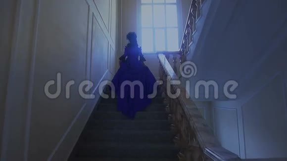 穿着蓝色裙子爬楼梯的漂亮女孩视频的预览图
