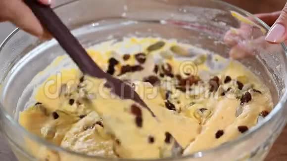 一位女糕点厨师的手把面团混合在碗里用铲子搅拌然后合上视频的预览图