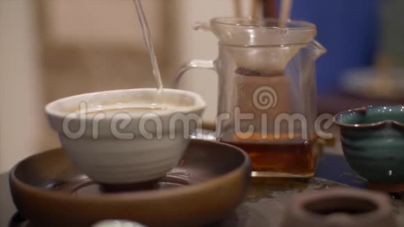 男人用绿茶把热水倒进碗里传统茶道视频的预览图