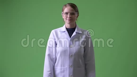 年轻快乐的女医生戴着防护眼镜交叉双臂视频的预览图