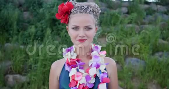 夏威夷女人有粉红色兰花的花蕾花环美丽微笑的白种人女子比基尼在海滩的视频的预览图