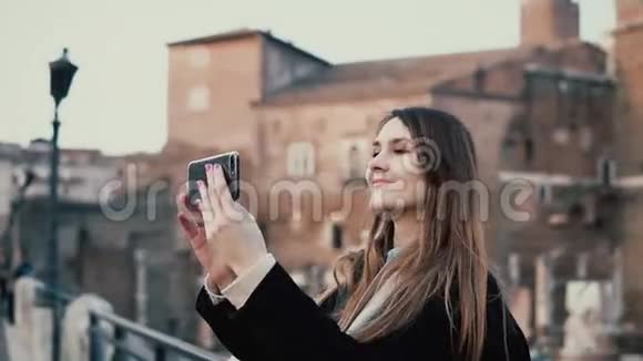 旅游女性在罗马论坛的背景下制作自拍使用智能手机女孩在意大利罗马度假视频的预览图