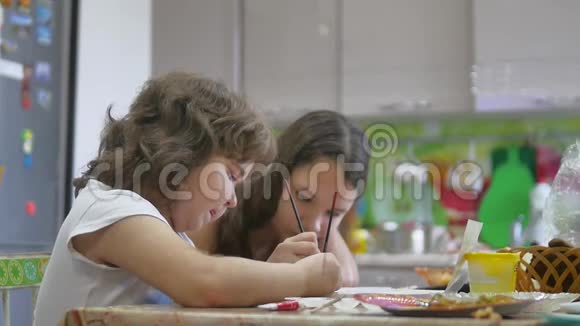 胖女孩画画孩子们画一幅画胖女孩画慢动作视频孩子们在室内画画视频的预览图