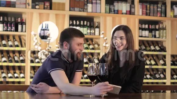 恋爱中的情侣在咖啡馆里坐着在电话里自拍美丽的年轻夫妇在自拍微笑着视频的预览图