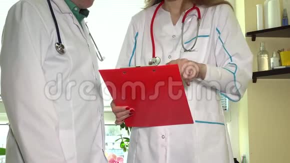 熟练的男性医生为有病人夹的女性同事提供建议视频的预览图