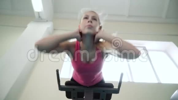 健身房里的女孩对背部肌肉进行锻炼催眠术视频的预览图