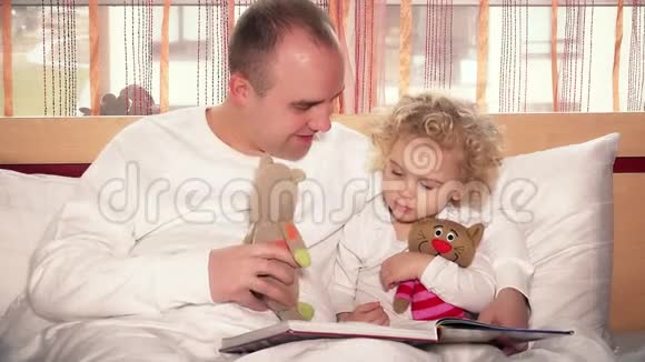 可爱的父亲用玩具猫玩她蹒跚学步的女儿视频的预览图