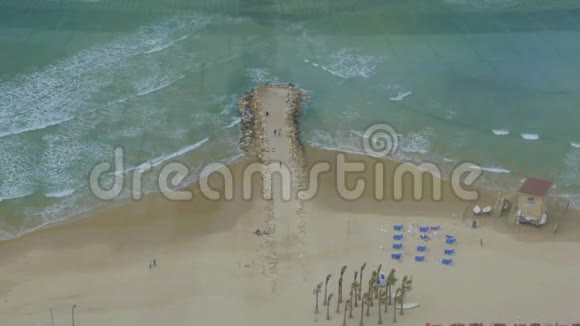 鸟瞰海滩和海洋与岩石码头视频的预览图
