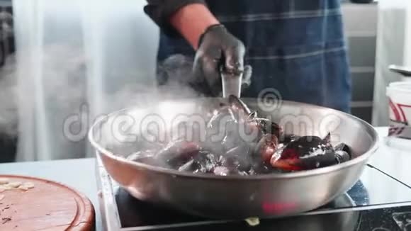 把贻贝放进煎锅里厨师将海鲜与油和调料混合视频的预览图