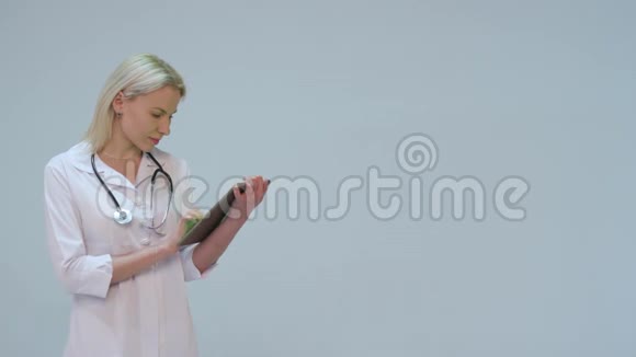 快乐而微笑的年轻医生在药片上打字视频的预览图