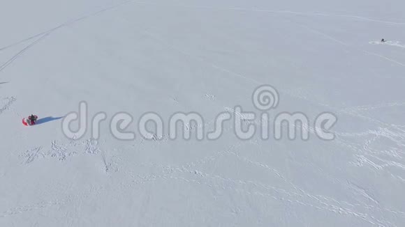 冬天的乐趣冰冻湖上的人们从事滑翔伞和冬季捕鱼视频的预览图