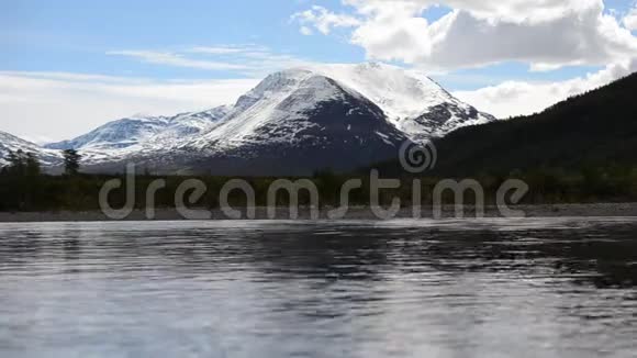 挪威北部的河水泛滥森林和雪山背景视频的预览图