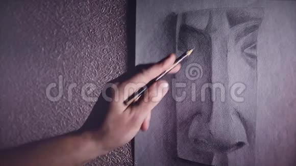 一位男艺术家用石墨铅笔画了一幅鼻子的石膏素描视频的预览图