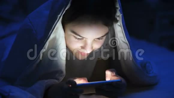 少女夜间在智能手机上玩游戏的画像视频的预览图