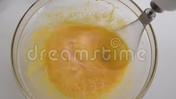 用电动搅拌器将新鲜鸡蛋倒入碗中近距离观看视频的预览图