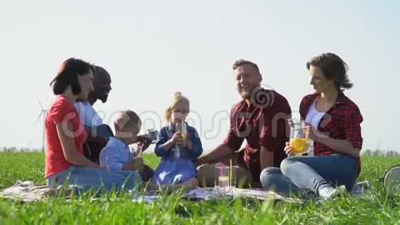 有孩子的人在野餐时休息喝水果水视频的预览图