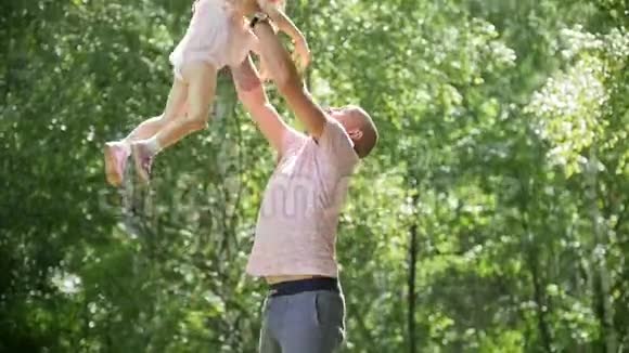 幸福的家庭父亲和他快乐的女儿在夏季公园慢动作视频的预览图