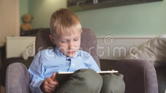 男孩在家里用平板电脑视频的预览图