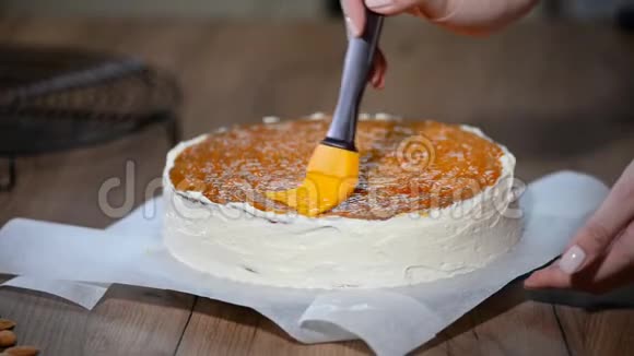 准备蛋糕在蛋糕上撒杏果酱视频的预览图