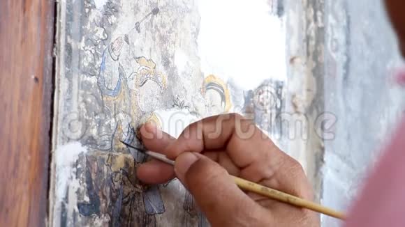 一位绘画艺术家的手在修理一幅中国画旧建筑墙体国画改造视频的预览图