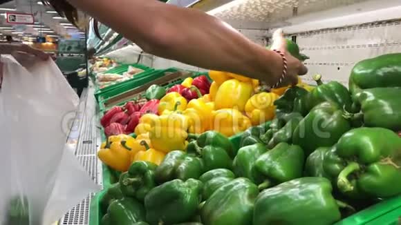 在超市里选择生的农场有机辣椒的女人视频的预览图