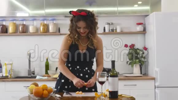 女人在家庭厨房的木制厨房板上切橘子在家做饭家庭气氛视频的预览图