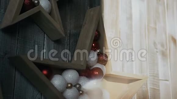 两颗星星从一棵树上飞过一个木头背景圣诞树装饰品圣诞节假期视频的预览图