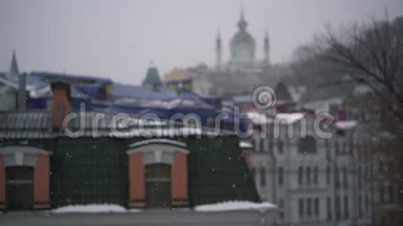 城市上空大雪纷飞建筑物的屋顶和窗户视频的预览图
