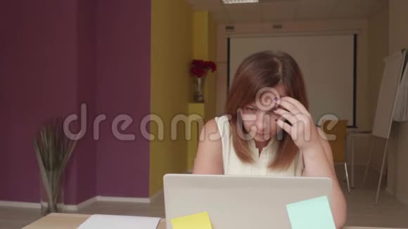 失望的女孩坐在笔记本电脑前写和扔纸有关视频的预览图