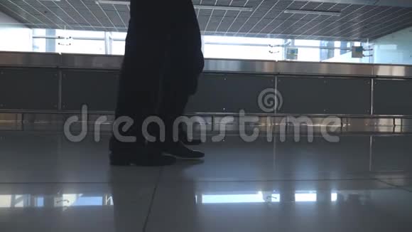 两个商人在机场候机楼散步商人们的腿踩在一起同事在室内视频的预览图