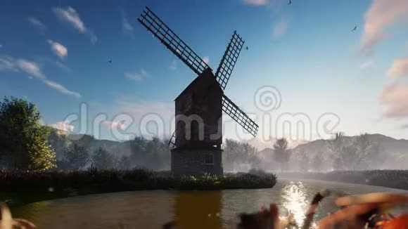 日出时在山和云的背景下传统的村庄风车矗立在池塘附近视频的预览图
