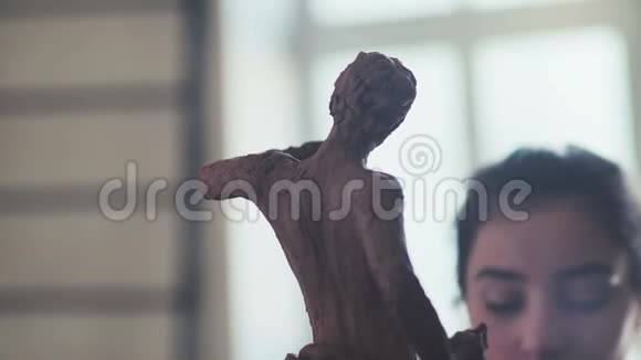 一位古代男子在女子面前用粘土雕塑家的脸视频的预览图