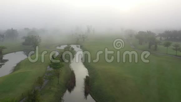 早上鸟瞰绿色高尔夫球场和雾视频的预览图