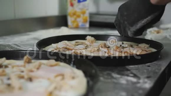 主厨准备了比萨饼蘑菇鸡肉和培根厨师准备一个披萨把配料放在面团上视频的预览图
