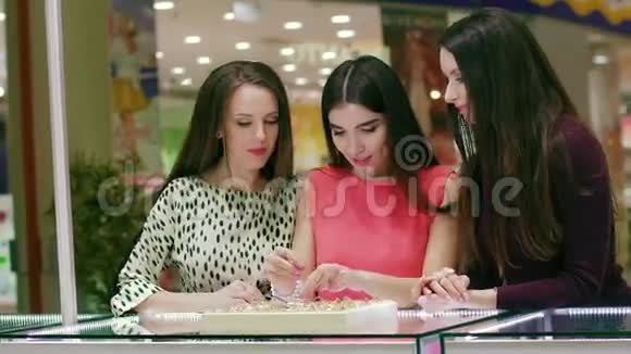 三个年轻女人选择合适的戒指视频的预览图