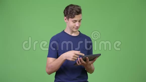 年轻英俊的少年使用数码平板电脑视频的预览图