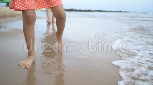 慢动作亚洲小女孩和妈妈在海滩上玩耍视频的预览图