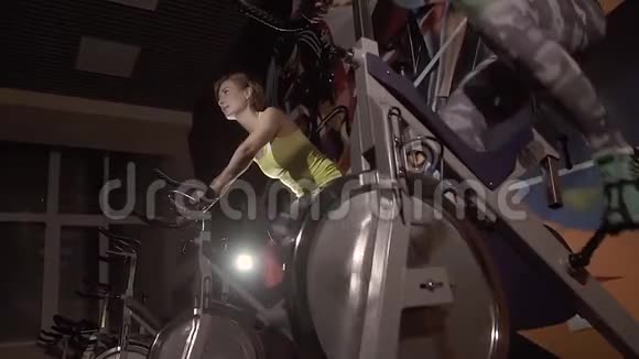 两名运动青年妇女使用固定自行车视频的预览图