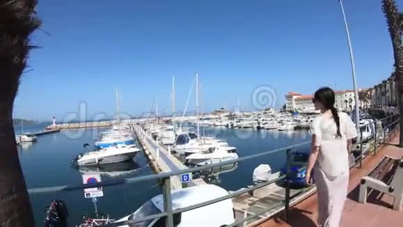 穿着裙子的女人在地中海港口和许多游艇散步法国视频的预览图