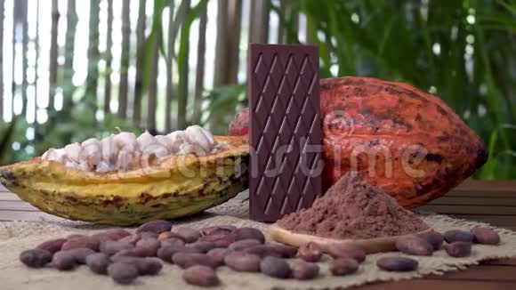 木制桌子上的苦巧克力棒生可可水果可可豆可可粉视频的预览图