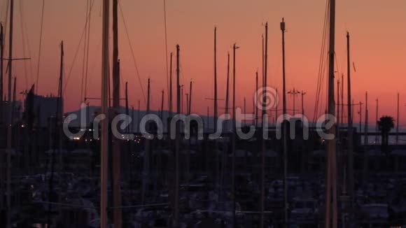 游艇剪影背景晚城景观游艇港口和船桅视频的预览图