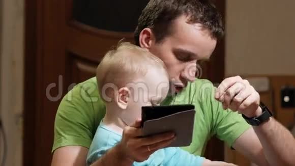 一个有魅力的男孩2岁父亲在家看书爸爸出示图片儿子叫动物视频的预览图